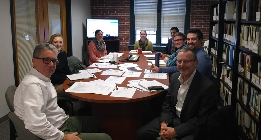 The CommuteSmart NH committee sits around a table at one of its meetings.