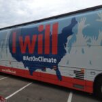 Bus with a wrap that reads "I will #Act On Climate"
