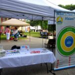 Interactive outreach display setup at a booth at the Middleton Yard Sale