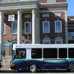 Two COAST buses wait in front of Dover City Hall