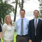 Panelist from the 2015 Tri-State Transit Conference pose in front of a lake