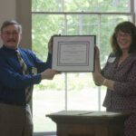 Photo of Executive Director Cynthia Copeland present the 2015 annual award to Dennis McCann of SEDC