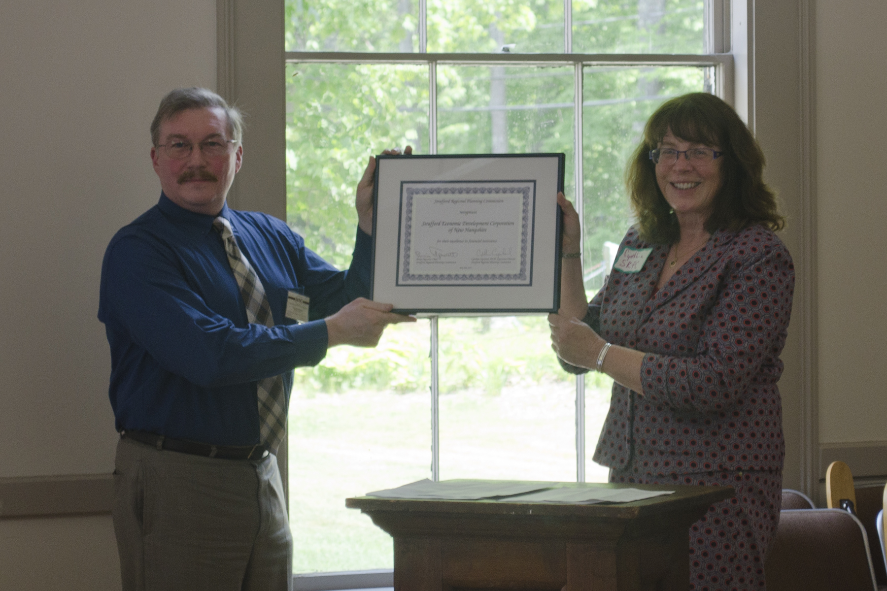 Photo of Executive Director Cynthia Copeland present the 2015 annual award to Dennis McCann of SEDC