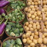 Farmer's market crops in baskets including mushrooms