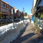 Snow plowed sidewalks in downtown Portsmouth amidst shops