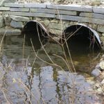 A double culvert with a smal stone wall atop it