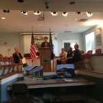Senator Shaheen stands at podium to announce Rochesters EDA grant at event in Rochester's City Council Chambers