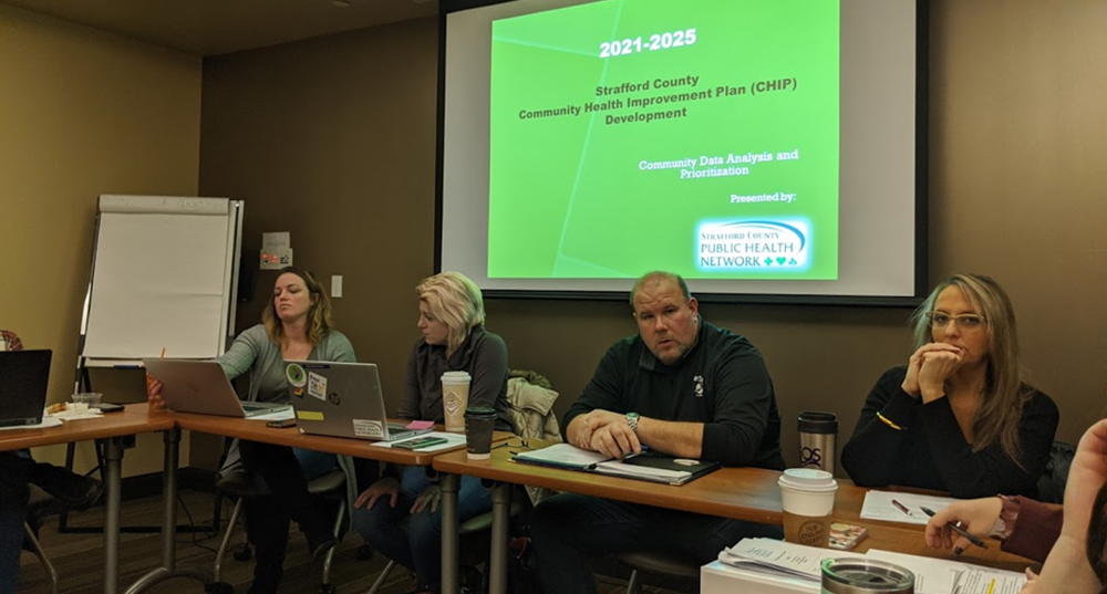 Members of the Strafford County Public Health Advisory Council (PHAC) Network meet around a table