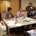 Stakeholders meet around a table as part of the Partnering for Performance NH initiative.
